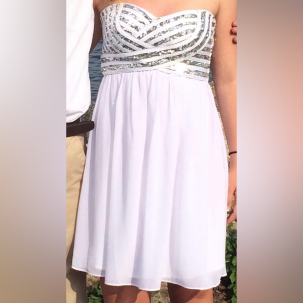 Strapless white dress with a sequined bodice zips up the side